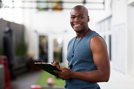 personal trainer with a clipboard